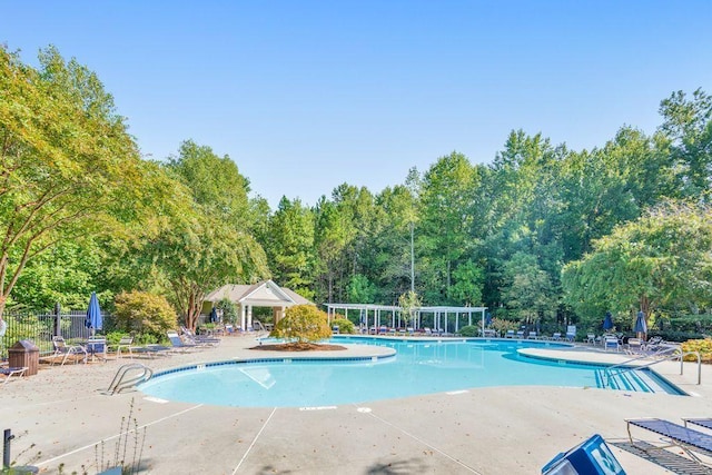 pool featuring a patio and fence