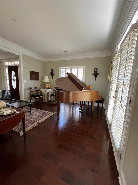 living area with visible vents, dark wood-style flooring, and ornamental molding