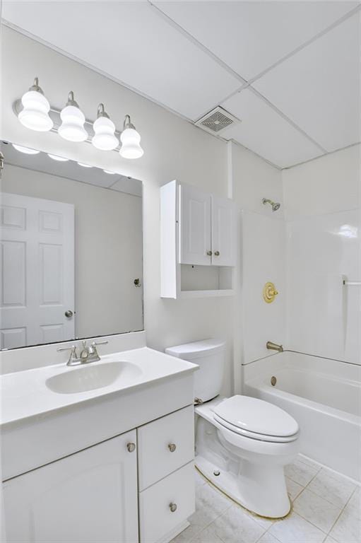 full bathroom with tile patterned floors, toilet, a paneled ceiling,  shower combination, and vanity