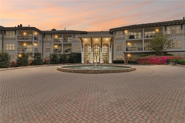 view of building exterior featuring curved driveway