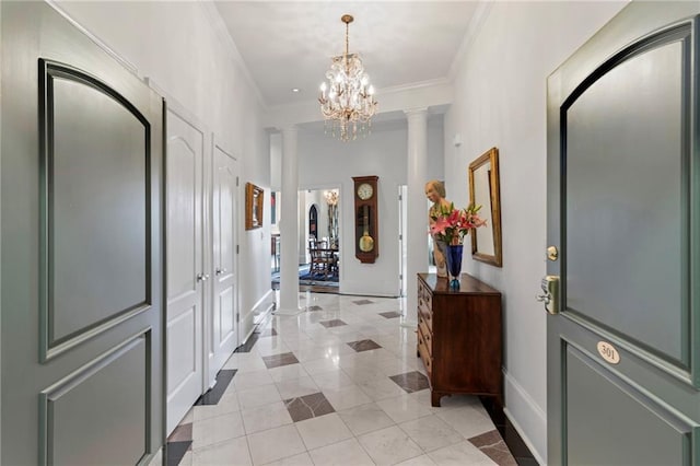 3101 Howell Mill Rd NW Unit 301, Atlanta, GA 30327 - foyer entrance featuring ornate columns, light tile patterned floors, ornamental molding, a chandelier, and baseboards
