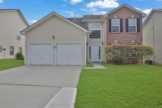 view of property featuring a front lawn and a garage