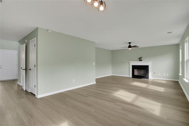 unfurnished living room featuring ceiling fan and light hardwood / wood-style flooring