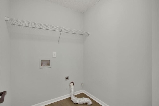 clothes washing area featuring hookup for a washing machine, hardwood / wood-style floors, and electric dryer hookup