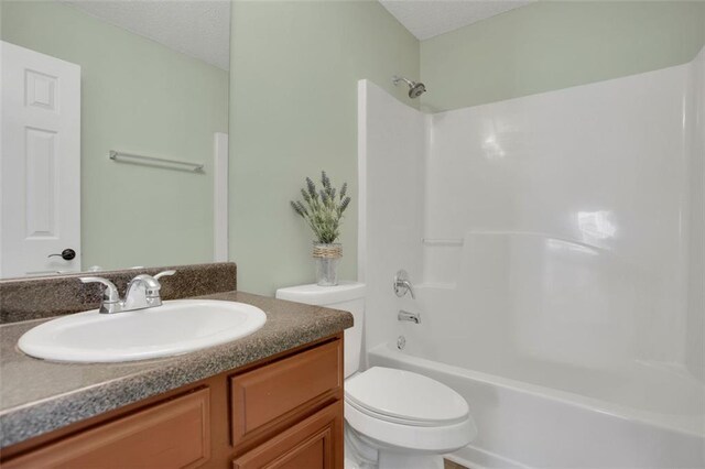 full bathroom with shower / bathtub combination, vanity, and toilet