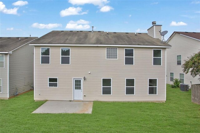 back of house with a patio area, central air condition unit, and a yard