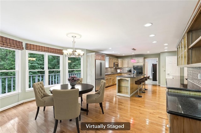8464 Pleasant Hill Rd, Lithonia, GA 30058 - dining space featuring light wood-style flooring, a chandelier, baseboards, and recessed lighting