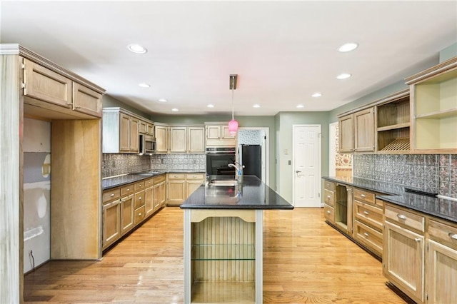 8464 Pleasant Hill Rd, Lithonia, GA 30058 - kitchen featuring light wood finished floors, decorative backsplash, appliances with stainless steel finishes, and recessed lighting