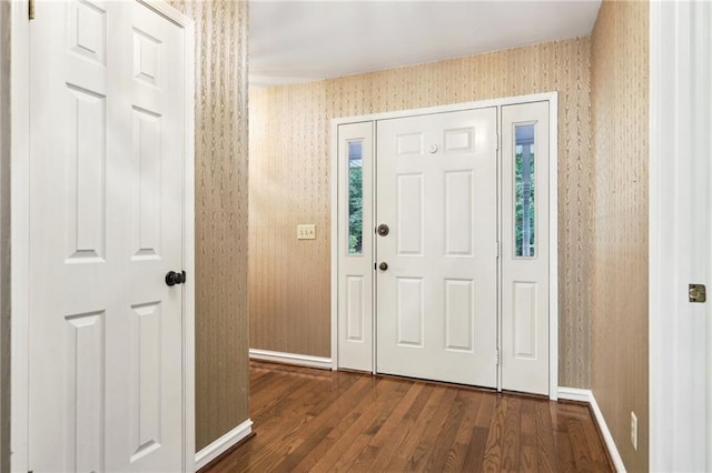 8464 Pleasant Hill Rd, Lithonia, GA 30058 - foyer with dark wood-style floors, wallpapered walls, and baseboards