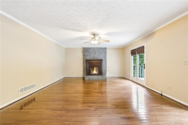 8464 Pleasant Hill Rd, Lithonia, GA 30058 - unfurnished living room with a ceiling fan, crown molding, wood finished floors, baseboards, and a fireplace