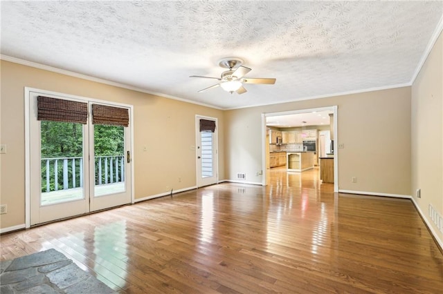 8464 Pleasant Hill Rd, Lithonia, GA 30058 - unfurnished living room featuring wood finished floors, ornamental molding, ceiling fan, a textured ceiling, and baseboards