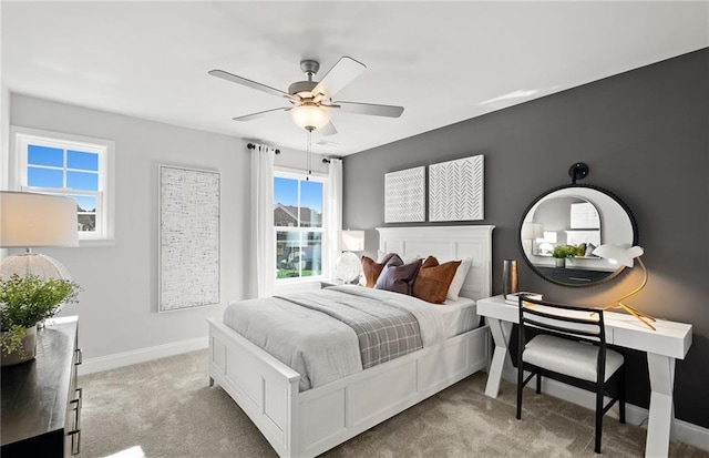 bedroom featuring ceiling fan and light carpet