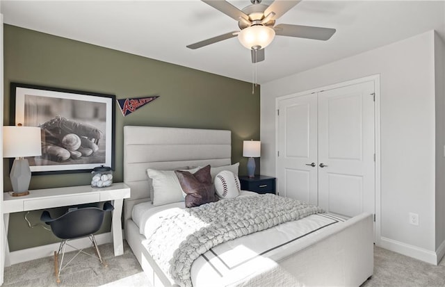 carpeted bedroom featuring ceiling fan and a closet