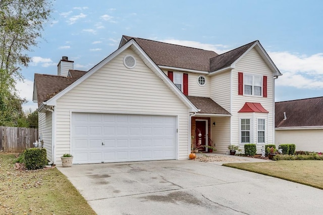 front of property featuring a garage and a front lawn