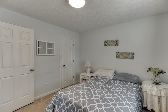 carpeted bedroom featuring a textured ceiling