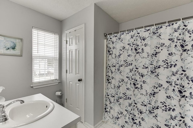 bathroom with vanity, a textured ceiling, and a shower with shower curtain