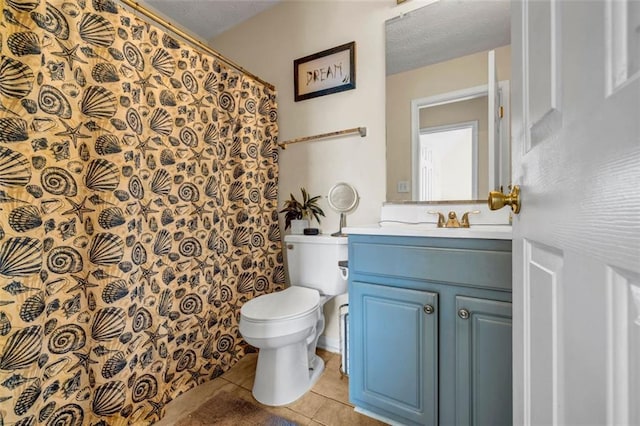 bathroom with toilet, vanity, a shower with curtain, tile patterned floors, and a textured ceiling