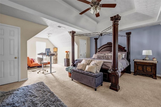carpeted bedroom featuring visible vents, a textured ceiling, a raised ceiling, ceiling fan, and vaulted ceiling