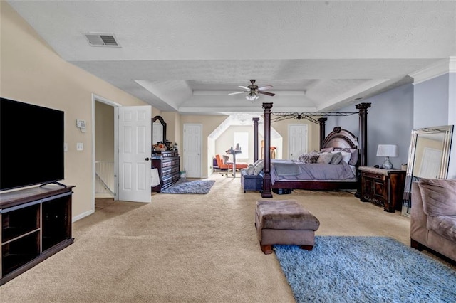 bedroom with visible vents, baseboards, a tray ceiling, carpet floors, and a ceiling fan
