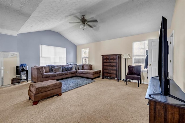 living area with ceiling fan, a textured ceiling, lofted ceiling, and carpet