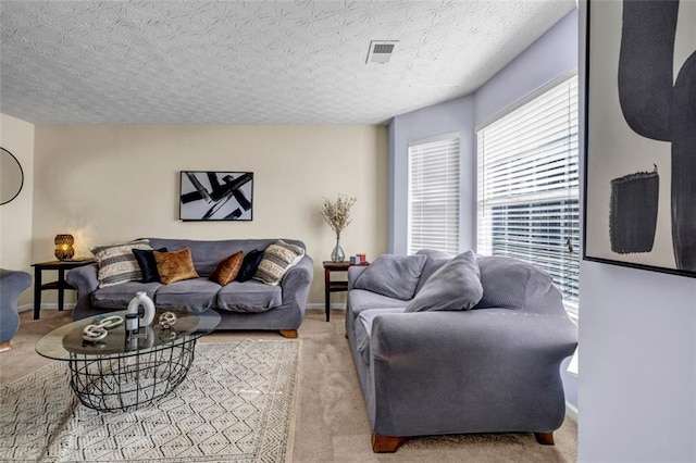 living area featuring visible vents, baseboards, and carpet floors