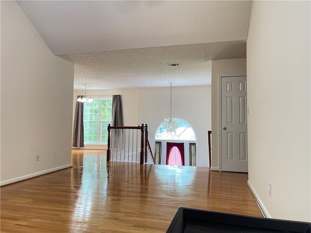 30 Buck Trl, Newnan, GA 30265 - dining space with a chandelier, wood finished floors, a textured ceiling, and baseboards