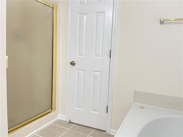 30 Buck Trl, Newnan, GA 30265 - bathroom with tile patterned floors, a stall shower, a bath, and baseboards