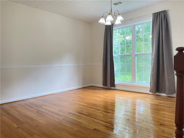 30 Buck Trl, Newnan, GA 30265 - empty room featuring wood finished floors, a chandelier, and baseboards