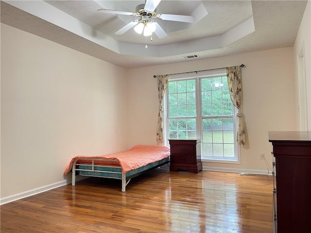 30 Buck Trl, Newnan, GA 30265 - bedroom with a tray ceiling, wood finished floors, baseboards, and a ceiling fan