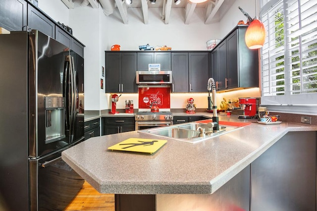 230 Bradberry St SW Unit 9, Atlanta, GA 30313 - kitchen featuring a sink, light wood-style floors, a peninsula, stainless steel appliances, and pendant lighting