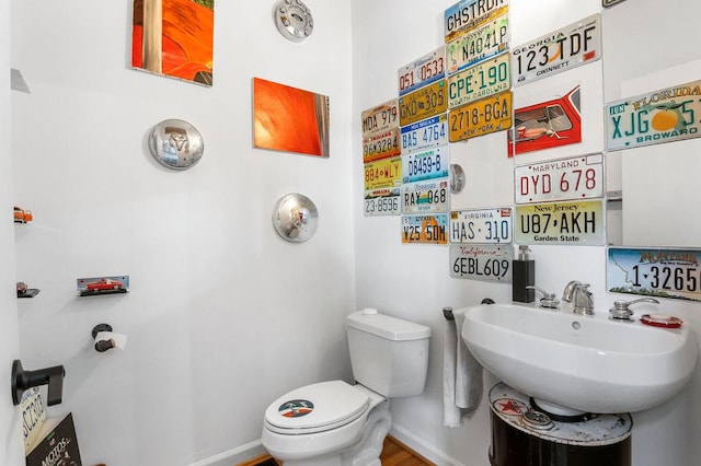 230 Bradberry St SW Unit 9, Atlanta, GA 30313 - half bathroom with baseboards, a sink, and toilet