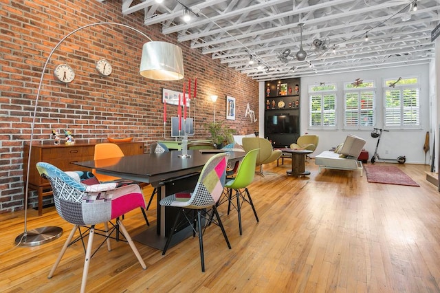 230 Bradberry St SW Unit 9, Atlanta, GA 30313 - dining space with brick wall, wood-type flooring, and rail lighting