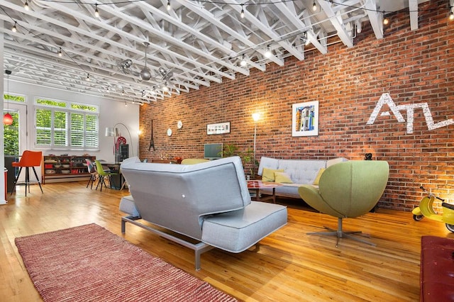 230 Bradberry St SW Unit 9, Atlanta, GA 30313 - living room featuring wood-type flooring and brick wall