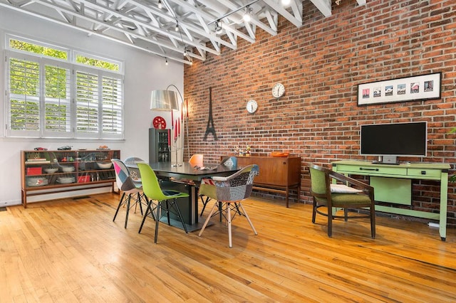 230 Bradberry St SW Unit 9, Atlanta, GA 30313 - dining space with track lighting, hardwood / wood-style floors, and brick wall