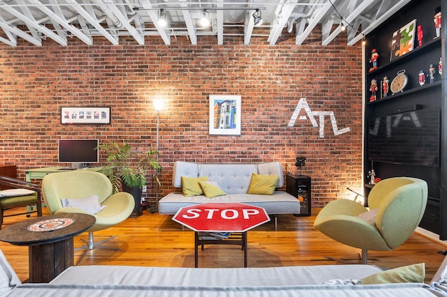 230 Bradberry St SW Unit 9, Atlanta, GA 30313 - living area featuring brick wall, rail lighting, and wood finished floors