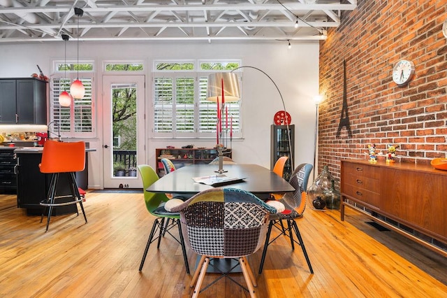 230 Bradberry St SW Unit 9, Atlanta, GA 30313 - dining area featuring brick wall and light wood finished floors