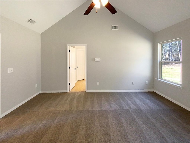 carpeted empty room featuring high vaulted ceiling, baseboards, and visible vents