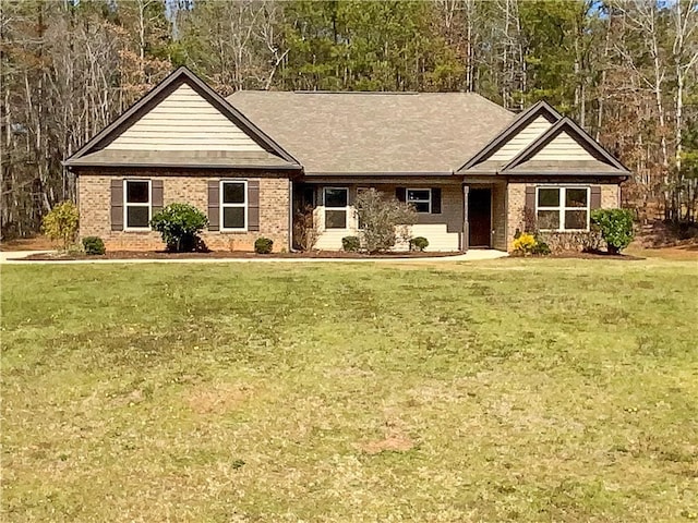 view of front facade with a front yard and brick siding