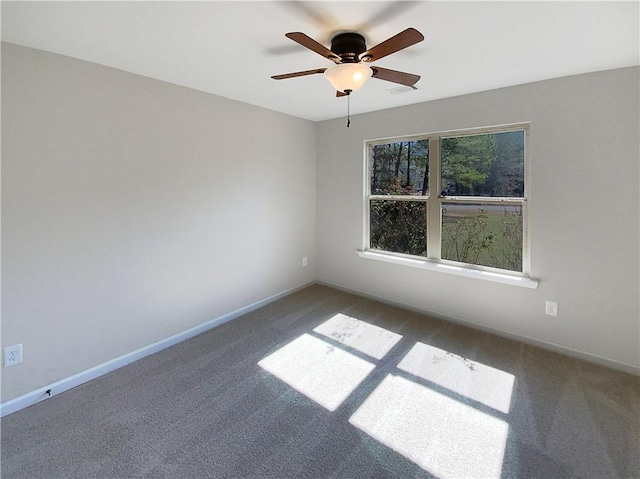 carpeted empty room featuring visible vents, baseboards, and a ceiling fan