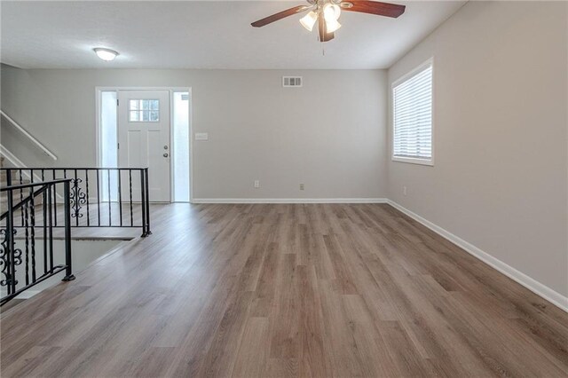 unfurnished room with ceiling fan and light wood-type flooring