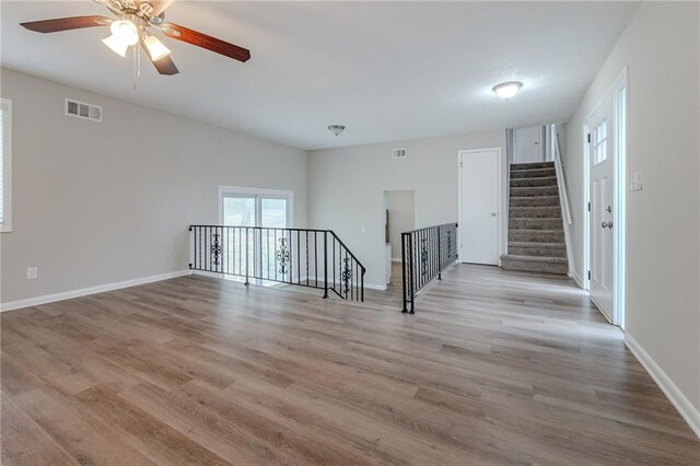 unfurnished room with ceiling fan and light wood-type flooring