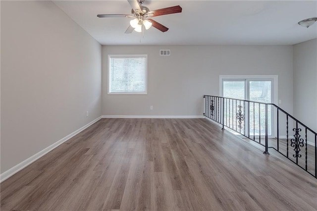 spare room with ceiling fan and light wood-type flooring