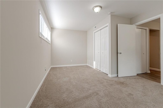 unfurnished bedroom with light colored carpet