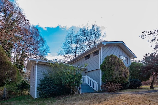 view of home's exterior with a lawn