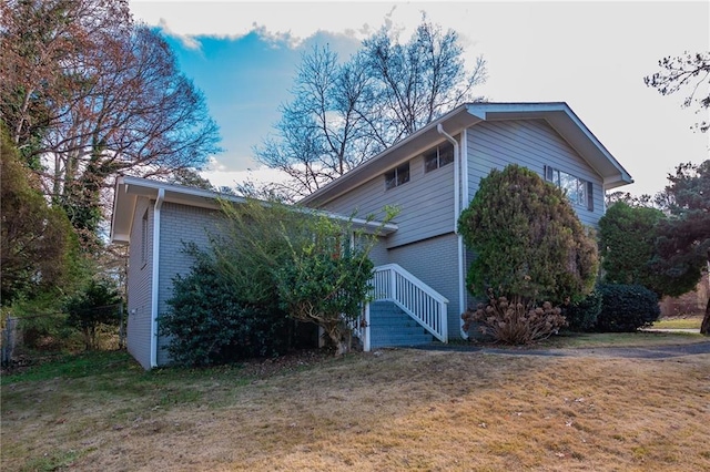 view of side of property with a yard