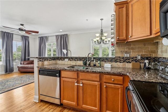 2465 Main St Unit 201, Atlanta, GA 30344 - kitchen with appliances with stainless steel finishes, brown cabinetry, a peninsula, light wood-style flooring, and decorative backsplash