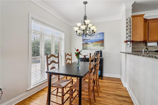 2465 Main St Unit 201, Atlanta, GA 30344 - dining area featuring a chandelier, light wood-style floors, and ornamental molding