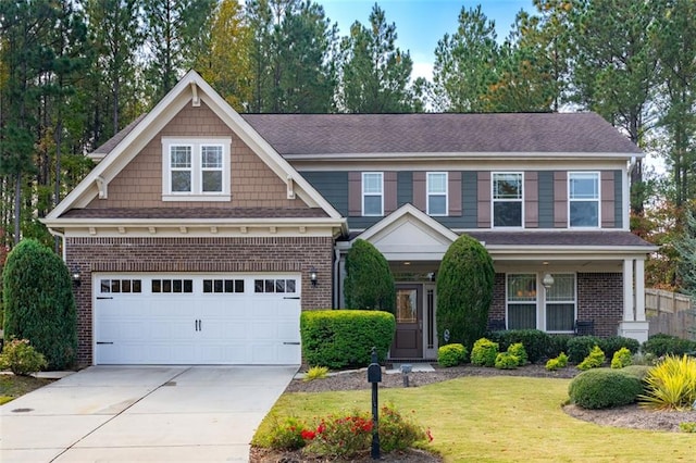 craftsman house featuring a garage and a front yard