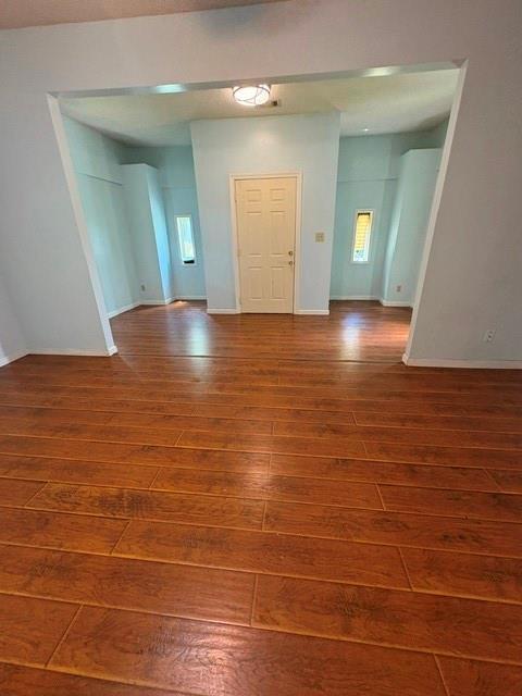 foyer featuring wood-type flooring and baseboards