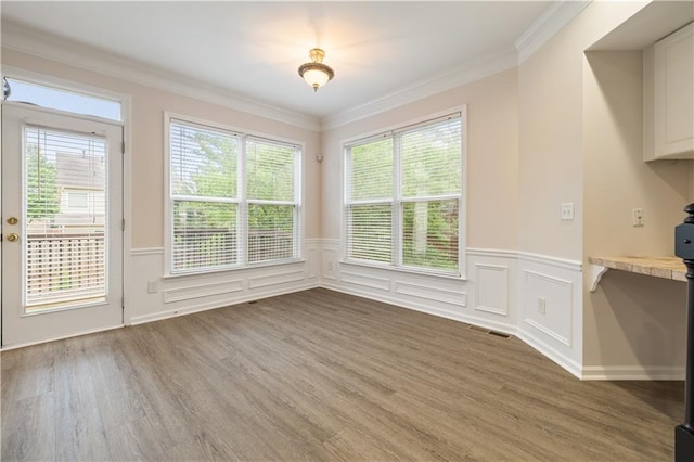 3382 Galleon Dr, Alpharetta, GA 30004 - unfurnished dining area featuring light wood-style floors, wainscoting, crown molding, and a decorative wall